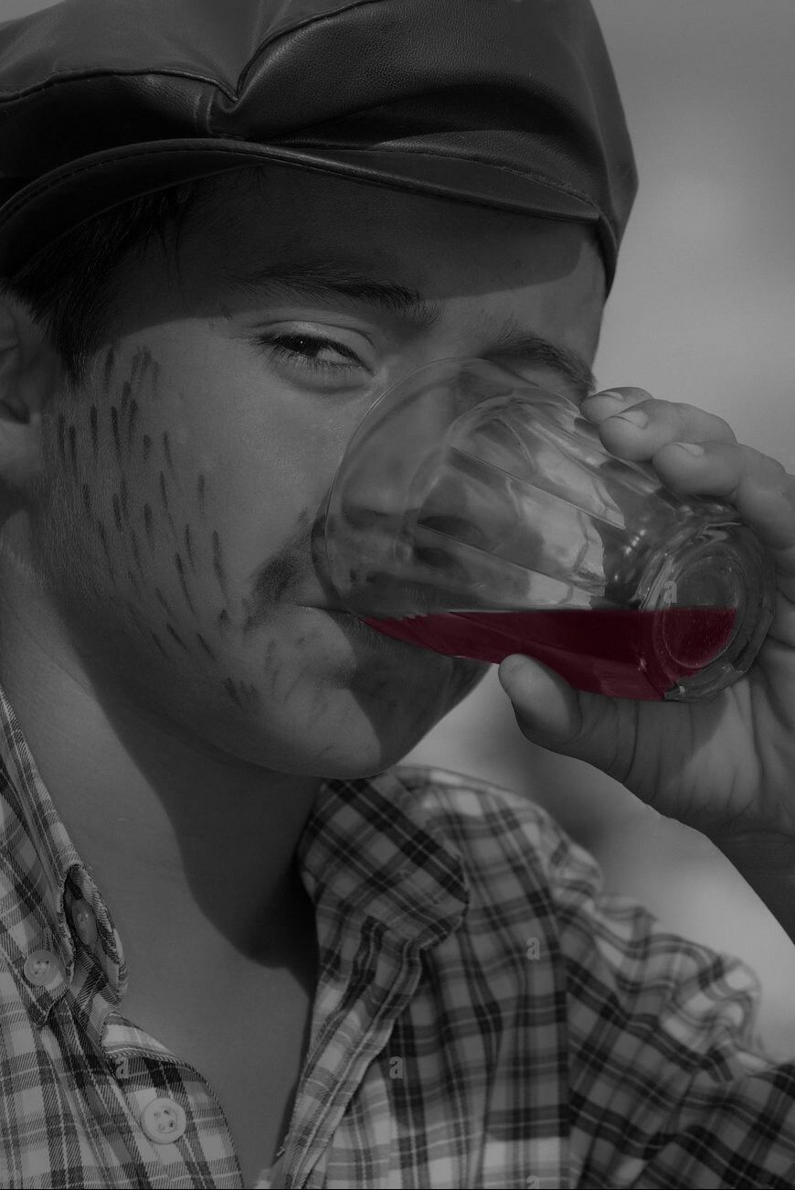 A man drinking Rioja wine from a crystal glass.