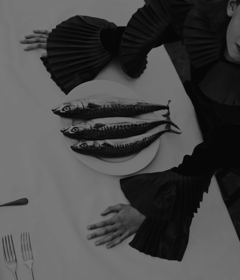 A woman eating fish in a restaurant in Rioja.