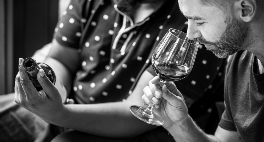 Man tasting red wine with friends